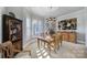 Dining room with a wooden table and chairs, plantation shutters, and unique lighting and cabinet features at 115 Amelia Ln, Mooresville, NC 28117