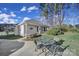 Charming home exterior with a cozy patio set, inviting landscaping, and a decorative tree wall hanging at 115 Amelia Ln, Mooresville, NC 28117