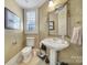 Elegant powder room featuring a pedestal sink, decorative mirror, and stylish fixtures at 115 Amelia Ln, Mooresville, NC 28117