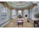 Bright sunroom with three large windows, plantation shutters, and a comfortable sitting area at 115 Amelia Ln, Mooresville, NC 28117