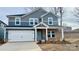 Two-story home with gray siding, brick accents, and a two-car garage at 115 Obadiah Ct, Mooresville, NC 28115