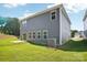 Back exterior of home, showcasing a well-maintained lawn, patio and modern siding at 115 Obadiah Ct, Troutman, NC 28115