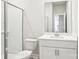Modern bathroom with a glass-enclosed shower, white vanity, and bright lighting at 115 Obadiah Ct, Troutman, NC 28115