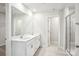 Bright bathroom featuring a double vanity, large mirror, and a glass-enclosed shower at 115 Obadiah Ct, Troutman, NC 28115