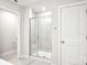 Bathroom featuring a walk-in shower with glass door and tiled walls, and neutral decor at 115 Obadiah Ct, Troutman, NC 28115