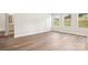 Spacious, brightly lit living room with light wood floors and several large windows at 115 Obadiah Ct, Troutman, NC 28115