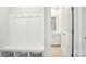 Functional mudroom with built-in bench seating, storage cubbies, and adjacent half bathroom at 115 Obadiah Ct, Troutman, NC 28115