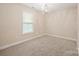 Well-lit bedroom with carpet, window, and chandelier at 119 Heritage Creek Dr, Hickory, NC 28601
