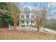 Two-story house with light yellow siding, white columns, and a white picket fence at 119 Heritage Creek Dr, Hickory, NC 28601