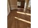 Sunlit living area with hardwood floors and access to dining area at 119 Heritage Creek Dr, Hickory, NC 28601