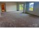 Finished basement features neutral carpeting and sliding glass door to the exterior at 13312 Chopin Ridge Rd, Huntersville, NC 28078