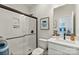 Bathroom featuring sleek glass enclosed shower, modern vanity, framed art, and neutral design at 13312 Chopin Ridge Rd, Huntersville, NC 28078