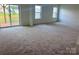 Spacious bedroom with plush carpeting and a sliding glass door to a patio at 13312 Chopin Ridge Rd, Huntersville, NC 28078