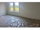 This room features carpeting and windows offering views of the community at 13312 Chopin Ridge Rd, Huntersville, NC 28078