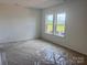 Unfinished bedroom with two windows, offering ample natural light and views of the neighborhood at 13312 Chopin Ridge Rd, Huntersville, NC 28078