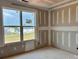 A bright, unfinished bedroom with a large window offering views of the surrounding neighborhood at 13312 Chopin Ridge Rd, Huntersville, NC 28078