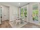 Cozy breakfast nook with a round table, white chairs, and natural light from a large window at 13312 Chopin Ridge Rd, Huntersville, NC 28078