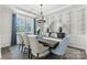 Elegant dining room with modern lighting fixture, large window, and stylish wallpaper at 13312 Chopin Ridge Rd, Huntersville, NC 28078