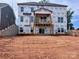 New construction home featuring a wooden balcony, with Tyvek wrap installed at 13312 Chopin Ridge Rd, Huntersville, NC 28078