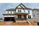 Unfinished two-story home with an attached two car garage and a covered front porch at 13312 Chopin Ridge Rd, Huntersville, NC 28078