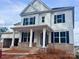 Charming two-story home with white siding, black shutters, and a welcoming covered front porch at 13312 Chopin Ridge Rd, Huntersville, NC 28078