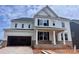 New construction, two-story home showcasing modern white siding and brick accents at 13312 Chopin Ridge Rd, Huntersville, NC 28078