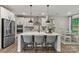 Spacious kitchen featuring a large island, breakfast bar, and stainless steel refrigerator at 13312 Chopin Ridge Rd, Huntersville, NC 28078