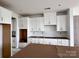 Spacious kitchen with white cabinets and modern design elements awaiting final touches at 13312 Chopin Ridge Rd, Huntersville, NC 28078