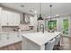 Modern kitchen with a large center island, pendant lighting, and stainless steel appliances at 13312 Chopin Ridge Rd, Huntersville, NC 28078