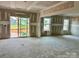 Unfinished living room with sliding glass doors to the backyard allowing ample natural light at 13312 Chopin Ridge Rd, Huntersville, NC 28078