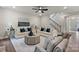 Elegant living room with comfortable seating, neutral tones, and a view of the staircase at 13312 Chopin Ridge Rd, Huntersville, NC 28078