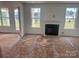 Spacious living room with fireplace, large windows, and access to outdoor area at 13312 Chopin Ridge Rd, Huntersville, NC 28078