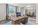 Bright home office featuring a large desk, comfortable chair, and views of the front yard at 13312 Chopin Ridge Rd, Huntersville, NC 28078