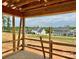Unfinished covered porch with wooden supports overlooking the landscape of other houses at 13312 Chopin Ridge Rd, Huntersville, NC 28078