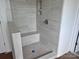 Modern shower with gray tile surround and built-in bench seating at 13312 Chopin Ridge Rd, Huntersville, NC 28078
