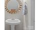 Small bathroom with pedestal sink and decorative mirror at 13823 Waverton Ln, Huntersville, NC 28078