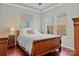 Bright bedroom with a wooden sleigh bed, hardwood floors and large windows at 13823 Waverton Ln, Huntersville, NC 28078