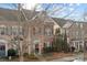 Brick front exterior of three-story townhome with landscaping at 13823 Waverton Ln, Huntersville, NC 28078