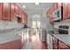 Modern kitchen with dark wood cabinets and stainless steel appliances at 13823 Waverton Ln, Huntersville, NC 28078