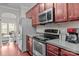 Kitchen boasts stainless steel appliances and a view into the living area at 13823 Waverton Ln, Huntersville, NC 28078