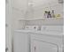 Bright laundry room with washer, dryer, and shelving at 13823 Waverton Ln, Huntersville, NC 28078