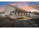 Evening view of backyard with screened porch at 145 Chertsey Dr, Mooresville, NC 28115