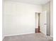 Spacious bedroom with door to hallway at 145 Chertsey Dr, Mooresville, NC 28115