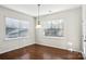 Bright breakfast room with hardwood floors and window blinds at 145 Chertsey Dr, Mooresville, NC 28115