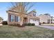 Brick home with a two-car garage and mature tree at 145 Chertsey Dr, Mooresville, NC 28115