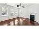 Living room with hardwood floors, fireplace, and ceiling fan at 145 Chertsey Dr, Mooresville, NC 28115