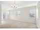 Main bedroom with carpet flooring, chandelier, and multiple windows at 145 Chertsey Dr, Mooresville, NC 28115