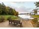 Picturesque lake view from a community space with seating, landscaping, and serene water backdrop at 18742 Nautical Dr # 305, Cornelius, NC 28031