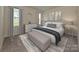 Main bedroom with neutral tones, carpet, and ample natural light at 2033 Old Rivers Rd, Concord, NC 28027