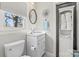 Bright bathroom featuring a single vanity, toilet, and window at 222 Ingram Rd, Statesville, NC 28625